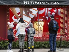 Pedestrians admire Christmas window displays at a Hudson's Bay store in downtown Toronto in a file photo from Dec. 5, 2019.