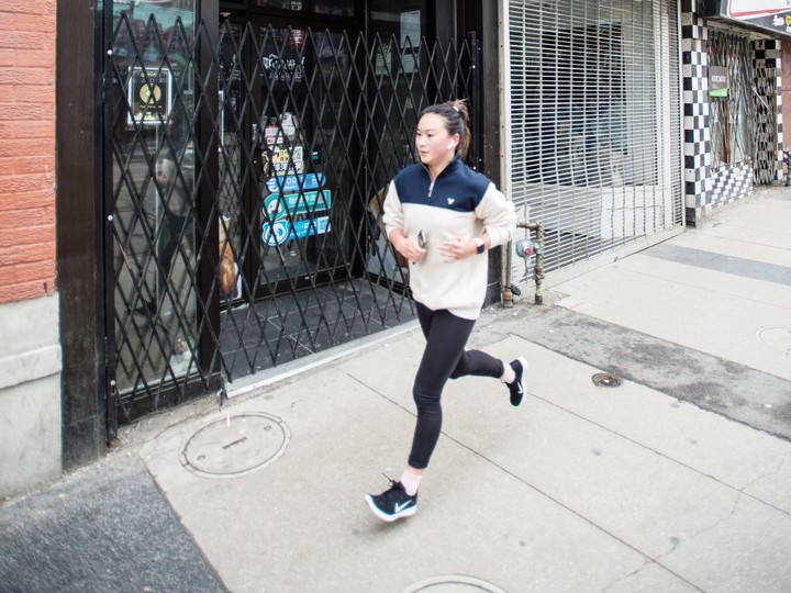  A woman jogs past shuttered businesses on Toronto’s Yonge Street during ongoing concerns of COVID-19 on March 19, 2020. 