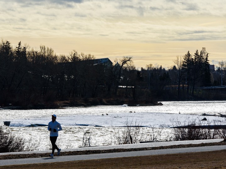  A jogger spends the morning on the Riverwalk path in Calgary, Alberta, on April 23, 2020. 