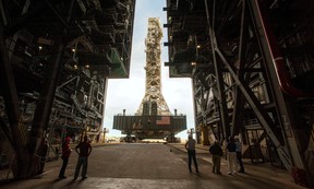 NASA employees look on as the Artemis launch tower rolls back from Pad 39B inside Bay 3 of the Vehicle Assembly Building (VAB) at the Kennedy Space Center in Cape Canaveral, Florida, U.S., on August 30, 2019.