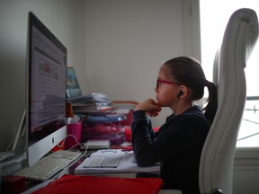 A student attends her online lessons in her bedroom in Paris, as a lockdown is imposed to slow the rate of the coronavirus in France, on March 20.