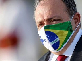 Brazil's interim Health Minister Eduardo Pazuello wears a protective face mask as he looks on before a national flag hoisting ceremony in front the Alvorada Palace, amid the coronavirus disease (COVID-19) outbreak, in Brasilia, Brazil June 9, 2020.