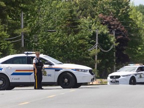 Members of the RCMP stand at the scene where a man was shot by police on Friday night, near Miramichi, N.B. on Saturday, June 13, 2020. Rodney Levi, 48, of the Metepenagiag First Nation, was fatally shot by New Brunswick RCMP Friday night.
