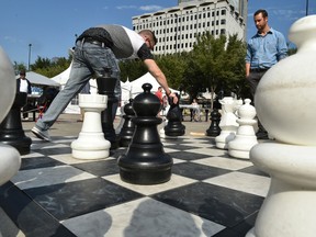 Players playing chess with pieces larger then the normal board size at Churchill Square  in Edmonton, August 24, 2017.