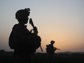 U.S. Marines with the 2nd Marine Expeditionary Brigade, RCT 2nd Battalion 8th Marines Echo Co. step off in the early morning during an operation to push out Taliban fighters on July 18, 2009 in Herati, Afghanistan.