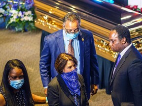 Minnesota Senator Amy Klobuchar(C, Reverend Jesse Jackson (behind) and Jonathan Jackson (R) show their respects to the remains of George Floyd at a memorial service in his honour on June 4, 2020, at North Central University's Frank J. Lindquist Sanctuary in Minneapolis, Minnesota.