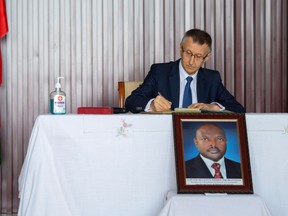 Ambassador of the Federal Republic of Russia to Burundi Valery Mikhaylov signs the condolences book following the death of Burundi's President Pierre Nkurunziza, at the State House in Bujumbura, Burundi June 10, 2020.