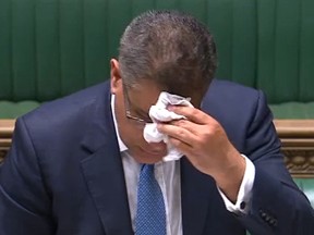 A video grab from footage broadcast by the UK Parliament's Parliamentary Recording Unit (PRU) shows Britain's Business Secretary Alok Sharma wiping his brow as he makes a statement in the House of Commons in London on June 3, 2020, as lockdown measures ease during the novel coronavirus COVID-19 pandemic.