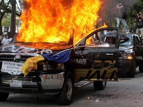 Demonstrators burn police vehicles during a protest following the death of a young man while in police custody, after he had been arrested allegedly for failing to comply with measures to prevent the spread of COVID-19 coronavirus, on June 4, 2020 in Guadalajara, state of Jalisco, Mexico.
