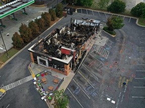 In this aerial photo, the Wendy's restaurant that was set on fire by demonstrators after Rayshard Brooks was killed by a police officer is seen on June 17, 2020 in Atlanta, Georgia. The site has become a place of remembrance for  Brooks, who was shot twice in the back after a struggle when police found him sleeping in his car in a Wendy's parking lot.