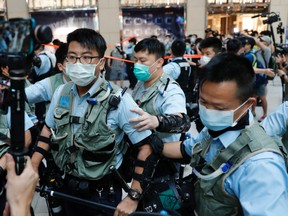 Police officers ask people to leave during a protest after China's parliament passes a national security law for Hong Kong, in Hong Kong, China June 30, 2020.