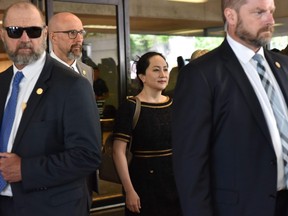 Huawei Chief Financial Officer, Meng Wanzhou (centre), leaves British Columbia Supreme Court in May 2020.