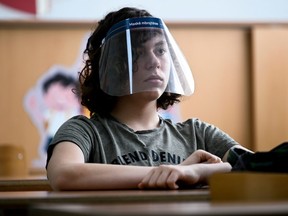 A student wears a face shield in Pristina, Kosovo, on June 9, 2020, as schools gradually reopen after almost three months of restrictions due to the COVID-19 pandemic. 
Eye protection is typically under-considered and can be effective in community settings according to a review that synthesized all available evidence on physical distancing, face masks and eye protection.