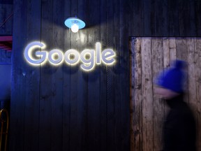 A man passes by Google's stand at the annual meeting of the World Economic Forum in Davos, Switzerland, on Jan. 21.