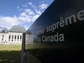 Clouds pass by the Supreme Court of Canada in Ottawa, Friday June 12, 2020. The court is set to release a ruling on francophone education issues.THE CANADIAN PRESS/Adrian Wyld