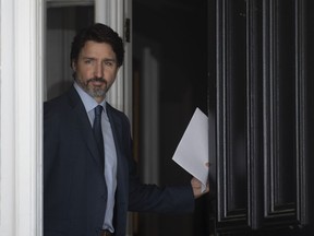 Prime Minister Justin Trudeau walks out the front door of Rideau Cottage as he makes his way to speak at a news conference at Rideau Cottage in Ottawa, Wednesday June 17, 2020.