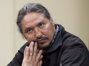 Chief Allan Adam of the Athabasca Chipewyan First Nation listens during a press conference in Fort McMurray, Alta. on Friday May 30, 2014.