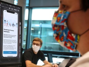 FILE PHOTO: Florian Heretsch and Emil Voutta of the developing team of software giant SAP work on the German government official COVID-19 tracing App at the SAP headquarters, as the spread of the coronavirus disease (COVID-19) continues, in Walldorf, Germany May 29, 2020.