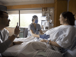 Maternity ward nurse Veronica Popa wears protective face mask and glasses as she checks in on Kate Chong in Vancouver this month. Most fertility clinics are now operating at reduced volumes during the pandemic.