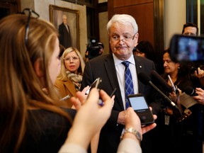Transport Minister Marc Garneau answers questions from the media on Parliament Hill in Ottawa, on March 9.