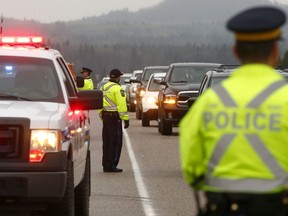 RCMP Traffic Services and Alberta Sheriffs are seen at a roadside Checkstop leading into the Victoria Day weekend on Highway 22 outside Bragg Creek. Thursday, May 16, 2019.