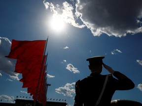 A paramilitary police officer salutes, after the closing session of the Chinese People's Political Consultative Conference in Beijing on May 27.