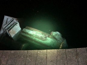 The statue of Christopher Columbus is seen in a lake after it was pulled down by protesters in Richmond, Virginia, U.S., on June 9, 2020, in this picture obtained from social media.