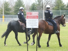 Toronto Police mounted unit and Toronto by-law enforcement officers were at the Bloor St. West entrance  High Park making sure about social distancing and telling people to move along and not gather in areas.  on Sunday April 5, 2020.