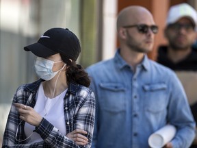 A Zara shopper wearing a mask linesup outside of the chains Queen Street West location during the Covid 19 pandemic, Monday June 15, 2020. [Peter J Thompson] [For National story by Sharon Kirkey/National]