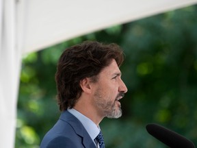 Prime Minister Justin Trudeau responds to a reporter's question during a news conference outside Rideau Cottage in Ottawa, after announcing a program aimed at encouraging students to volunteer, on June 22.