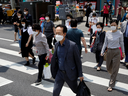 Pedestrians in face masks cross a street, amid the spread of COVID-19, in Seoul, South Korea.