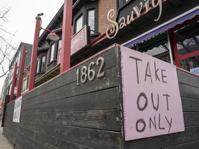 A restaurant in Toronto displays a "Take Out Only" sign on Wednesday, March 18, 2020. Ontario's two most heavily populated regions will see more businesses open their doors today as Toronto and Peel move into the next stage of the province's COVID-19 recovery plan.