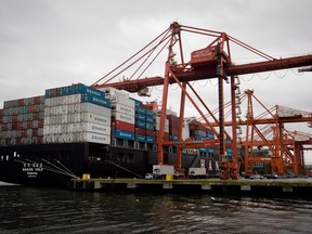 A container ship is unloaded at port in Vancouver, B.C., on Saturday December 23, 2012.