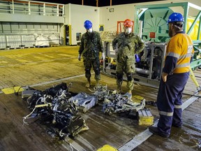 CF members and EDT Hercules personnel inspect recovered parts of the helicopter Stalker 22 during recovery operations for the aircraft in the Mediterranean Sea on May 31, 2020. Flight investigators have determined the military helicopter that crashed off the coast of Greece in April did not respond as the crew on board expected before going down into the Mediterranean Sea.