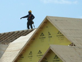 A construction worker works on a new home under construction in Oakville, Ont. on Friday, May 22, 2015. Canada Mortgage and Housing Corp. says it will re-assess all of its policies and practices through a racialized lens to eliminate discrimination. The federal housing agency says too few of its leaders are Black or Indigenous and noted that none are in senior management.
