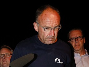 Douglas Garland is escorted into a Calgary police station in connection with the disappearance of Nathan O'Brien and his grandparents in Calgary, Alta., Monday, July 14, 2014. Alberta's top court is to hear arguments today in the sentencing appeal of a man who killed a Calgary couple and their five-year-old grandson six years ago.