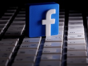 A 3D-printed Facebook logo is seen placed on a keyboard in this illustration taken March 25, 2020.