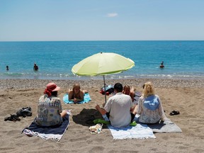 People enjoy on La Malagueta beach as some Spanish provinces are allowed to ease lockdown restrictions during phase two, amid the COVID-1) outbreak, in Malaga, southern Spain June 1, 2020.