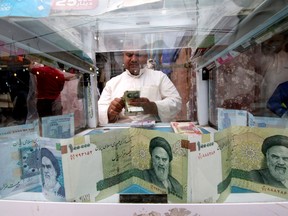 A man counts Iranian rials at a currency exchange shop, before the start of the U.S. sanctions on Tehran, in Basra, Iraq November 3, 2018.