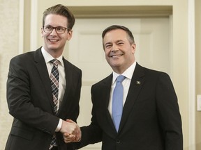 Alberta premier Jason Kenney shakes hands with Nate Glubish, Minister of Service Alberta after being sworn into office, in Edmonton on April 30, 2019. This year's most popular baby names in Alberta are Olivia for girls and Noah for boys. Service Alberta Minister Nate Glubish says it's the sixth year in a row that Olivia has been the queen of names for girls, with the name Charlotte this year's runner-up.