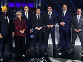 Host Patrice Roy from Radio-Canada, centre, introduces Federal party leaders, left to right, NDP leader Jagmeet Singh, Green Party leader Elizabeth May, People's Party of Canada leader Maxime Bernier, Liberal leader Justin Trudeau, Conservative leader Andrew Scheer, and Bloc Quebecois leader Yves-Francois Blanchet before the Federal leaders french language debate in Gatineau, Que. on October 10, 2019.