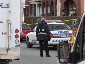 A Special Investigations Unit investigator works at the scene of a shooting in Toronto on Feb. 20, 2012. The agency that investigates police conduct in encounters resulting in serious injury will begin collecting race-based data later this year, the organization said on Thursday. Currently, the Special Investigations Unit only collects data on the age and gender of complainants. Recording new data will likely start Oct. 1, when new legislation is expected to take effect, spokeswoman Monica Hudon said.