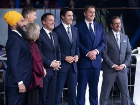 Host Patrice Roy from Radio-Canada, centre, introduces Federal party leaders, left to right, NDP leader Jagmeet Singh, Green Party leader Elizabeth May, People's Party of Canada leader Maxime Bernier, Liberal leader Justin Trudeau, Conservative leader Andrew Scheer, and Bloc Quebecois leader Yves-Francois Blanchet before the Federal leaders French language debate in Gatineau, Que. on October 10, 2019.