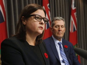 Manitoba Premier Brian Pallister listens in as Justice Minister Heather Stefanson talks during a press conference at the Manitoba Legislature in Winnipeg on November 7, 2017. Manitoba has announced the controversial practice that allows hospitals to notify child-welfare agencies about new mothers who are deemed to be high-risk will end this month. Families Minister Heather Stefanson says there will be no more birth alerts starting in July.