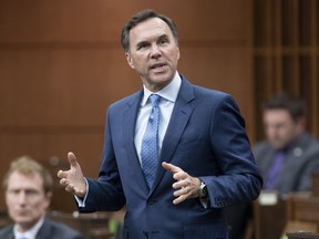 Finance Minister Bill Morneau rises during Question Period in the House of Commons in Ottawa on May 26, 2020. Finance Minister Bill Morneau says the government will look at how measures to revive the economy from its pandemic-induced freeze will impact women and men differently. He also suggests that federal officials will consider how any changes to the COVID-19 economic safety net may affect racialized communities in this country.