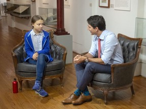 Canadian Prime Minister Justin Trudeau speaks to activist Greta Thunberg in Montreal on September 27, 2019. Thunberg is urging developing island nations to use the upcoming United Nations Security Council election to push Canada and Norway to step up their games on climate change. Thunberg is one of four youth activists and 22 climate scientists who signed a letter Tuesday to the ambassadors of countries within the UN's group of small island developing states.