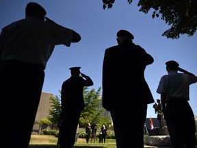 Korean War veterans along with Lt.Gen. Wayne Eyre, Commander of the Canadian Army, salute, second from left, during a ceremony commemorating the 70th anniversary of the Korean War at the Monument to the Canadian Fallen in Ottawa, on Sunday, June 21, 2020.
