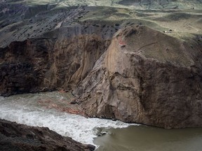 Workers are seen on the cliff at the site of a massive rock slide on the Fraser River near Big Bar, west of Clinton, B.C., on Wednesday July 24, 2019. Officials with the Department of Fisheries and Oceans say early arriving runs of Stuart and Chinook salmon were nearly wiped out after reaching the massive landslide along British Columbia's Fraser River last year.