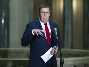 Saskatchewan Premier Scott Moe talks to reporters after the province released its budget at Saskatchewan's Legislative Building in Regina, Monday, June 15, 2020. Saskatchewan Premier Scott Moe says details are coming soon on when "virtually all" businesses in the province will be allowed to open.