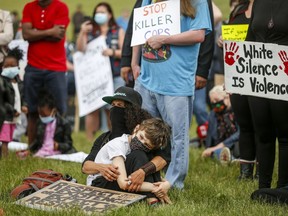 Black Lives Matter protesters gather in Innisfail, Alta., Saturday, June 13, 2020, amid a worldwide COVID-19 pandemic.